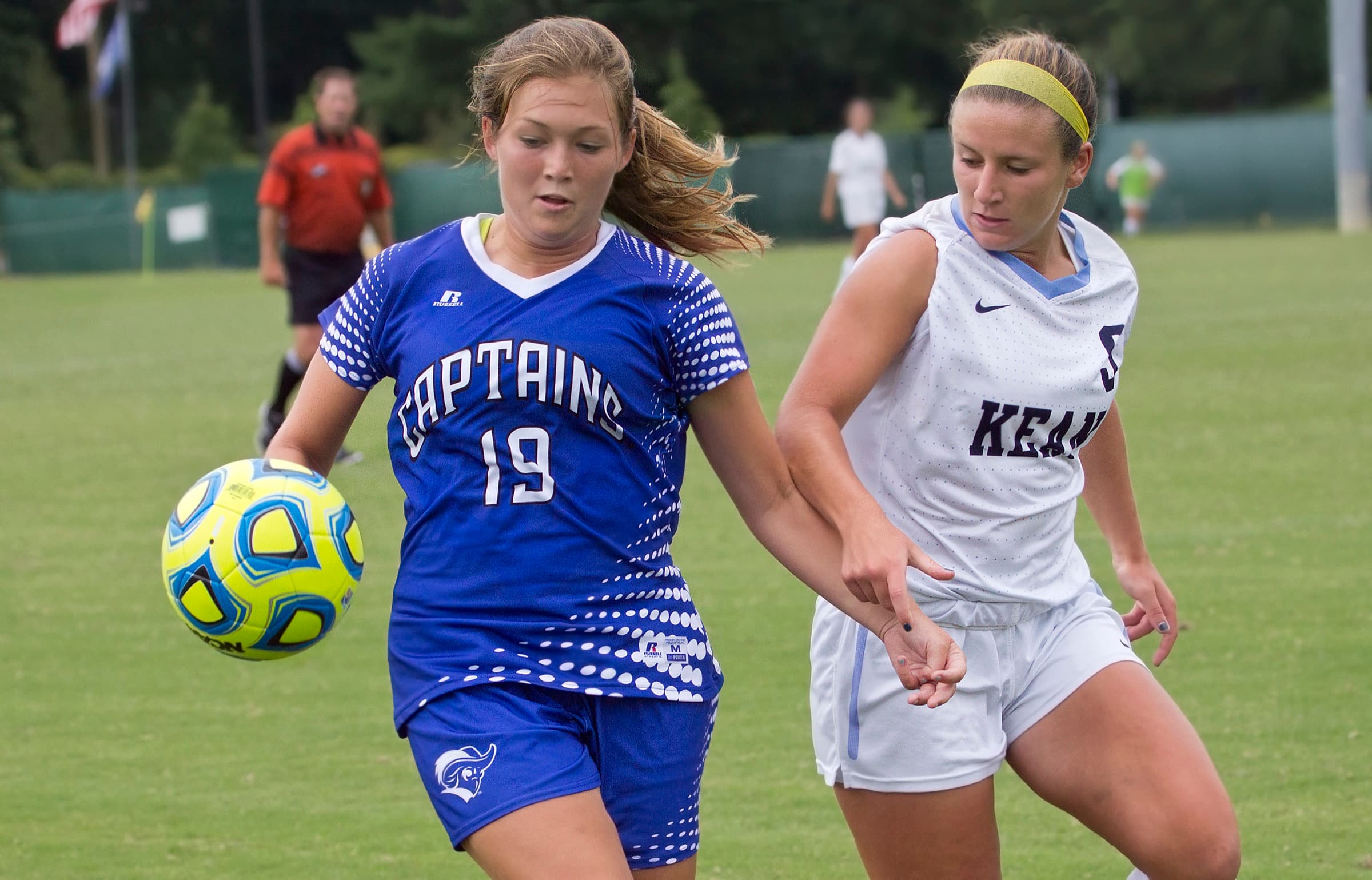 A Christopher Newport and a Kean women's player chasing the ball