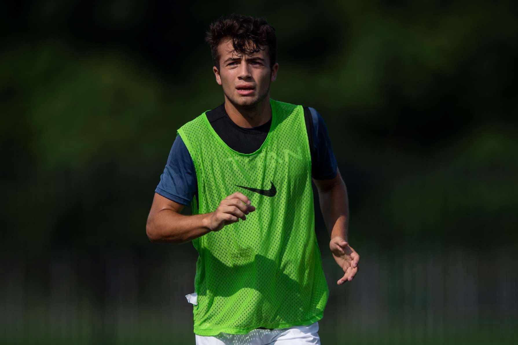 Ricky Ybarra in a training bib, running toward the camera